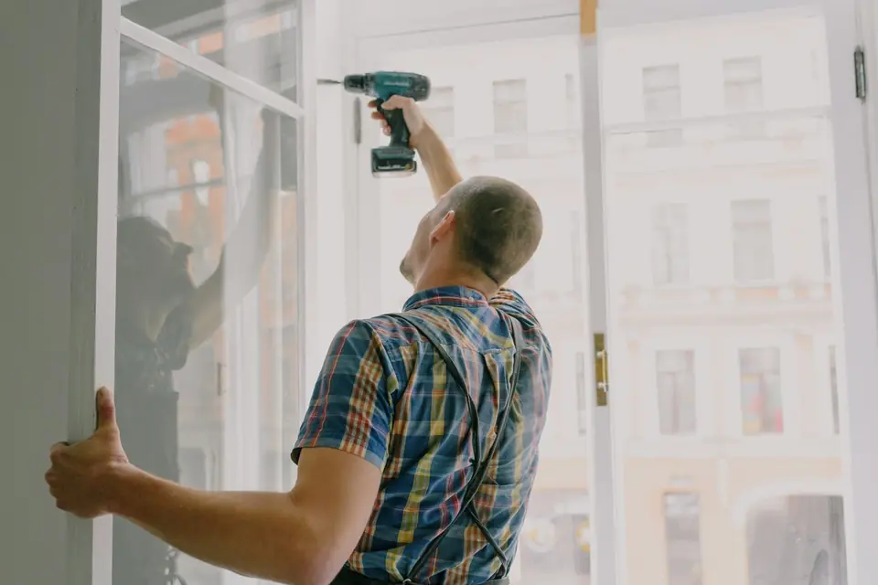 A fitter installing a new double glazed window