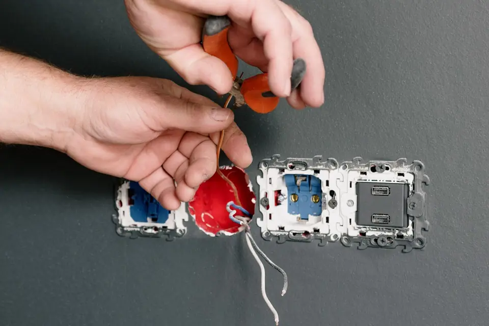 An electrician replacing a damaged socket