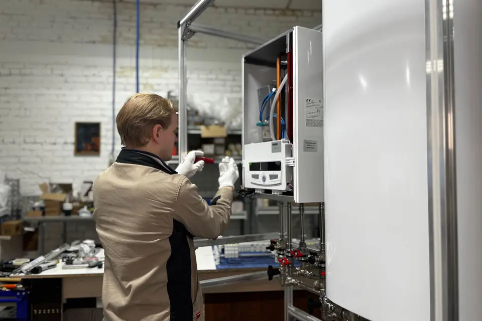 An engineer servicing a domestic gas boiler