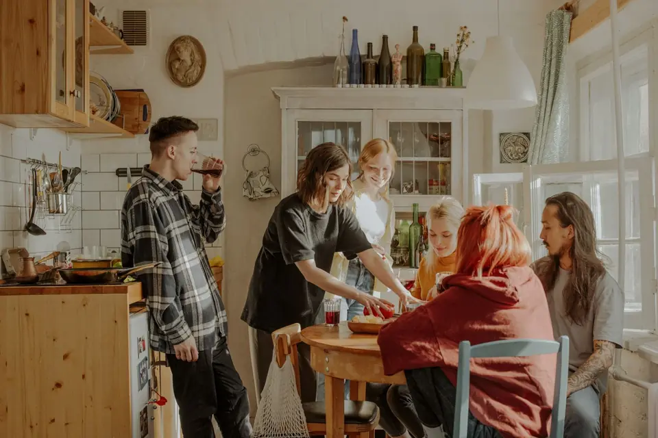 A group of housemates in a shared kitchen