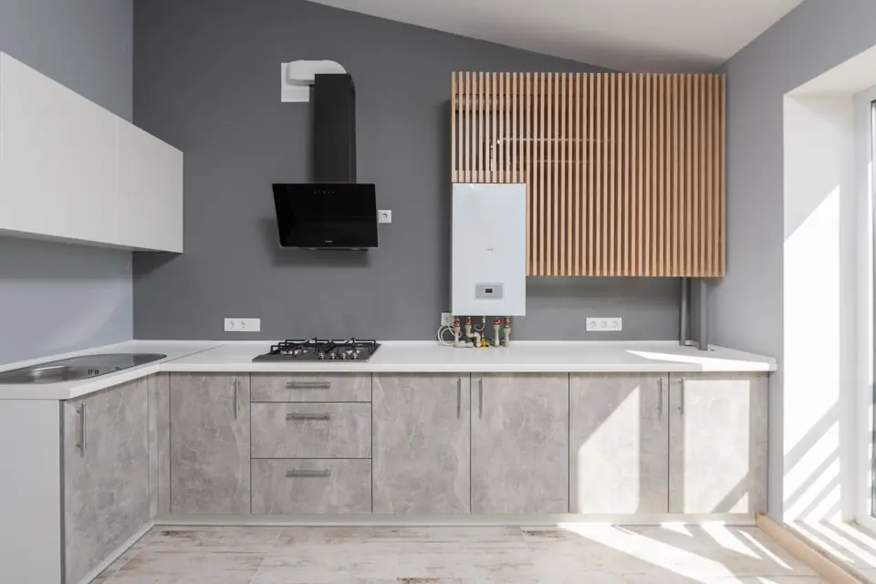 A wall-mounted combi boiler in a kitchen