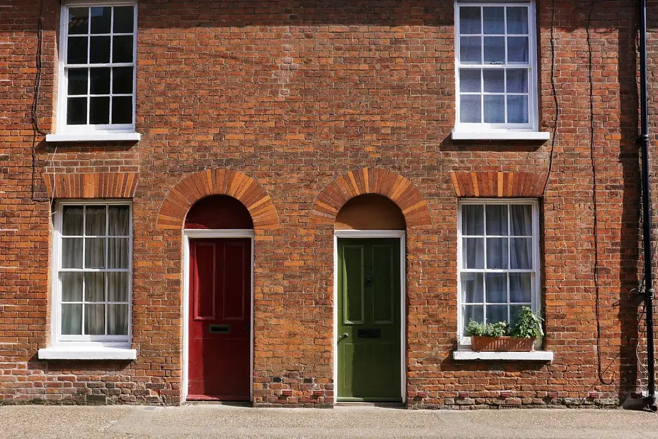 A brick terrace with painted front doors