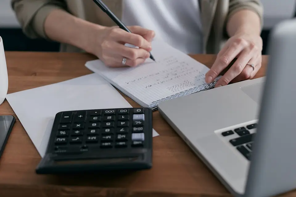 Receipts and a laptop used for bookkeeping